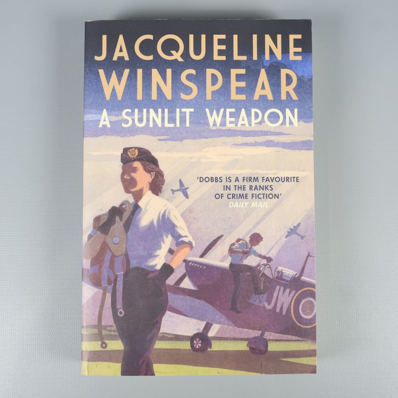 Bokens framsida med titeln A Sunlit Weapon och flygplansmotiv