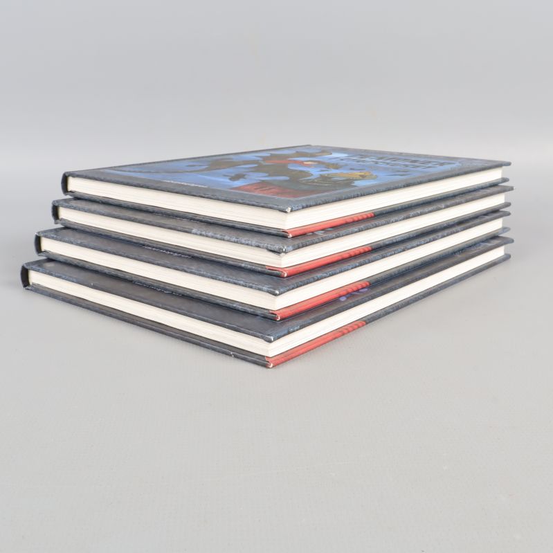 Fyra böcker i en stapel sedda från sidan