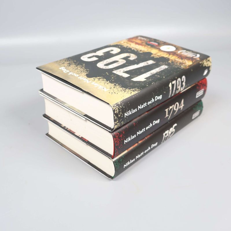 Snedvy av tre böcker i bokpaket, visar bokryggar och sidkanter