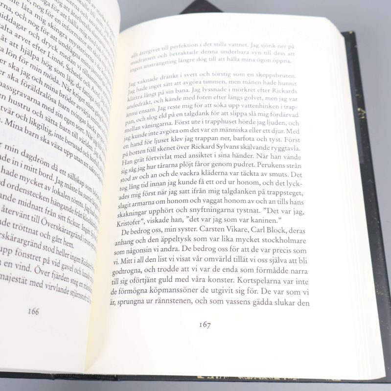 Uppslag ur bok med text på sidorna 166 och 167