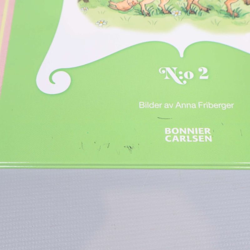 Närbild av bokomslag med smärre slitage och svarta märken på kanten