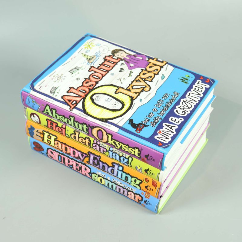 Fyra färgglada böcker staplade på hög med synliga omslag