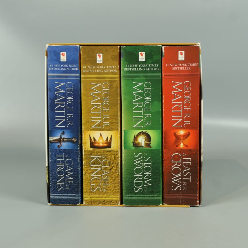 Fyra ryggar på Game of Thrones böcker med individuella färger