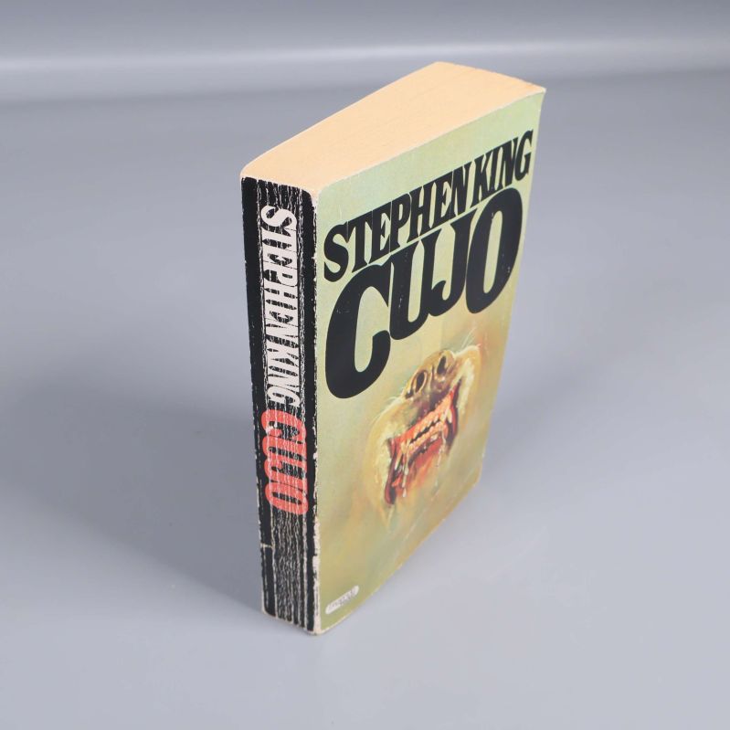 Cujo pocketbok stående, visar rygg och omslagets kant