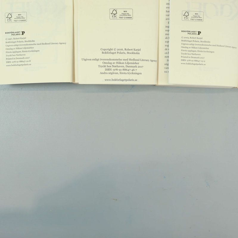 Uppslag i tre böcker med synliga ISBN och utgivarinformation