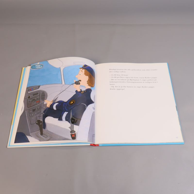 Illustration av polis och text på uppslag i Kråke-bok