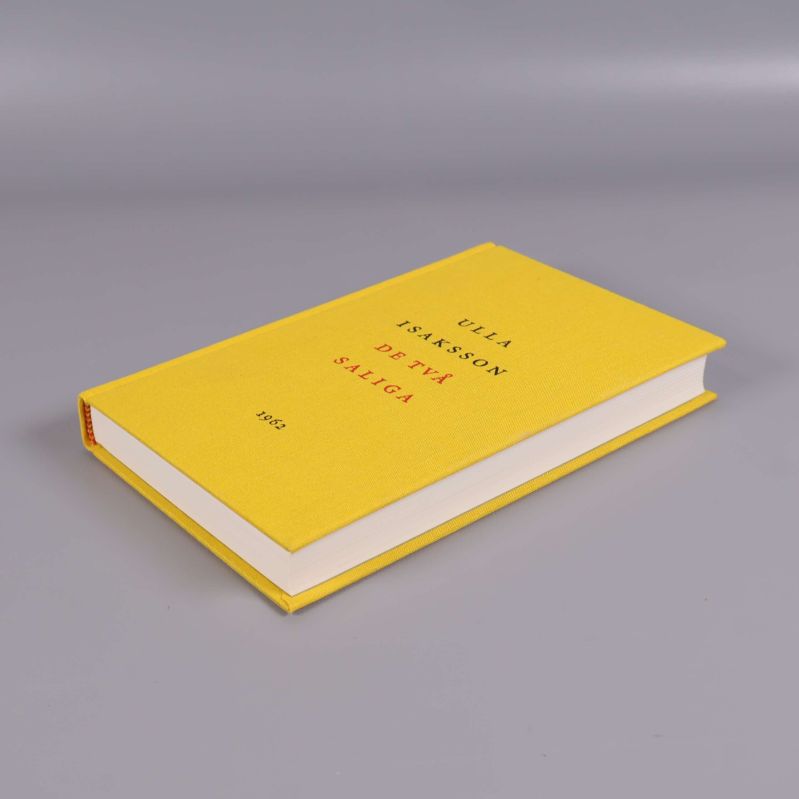 Boken De två saliga i vinkel, visande framsida och rygg ihop