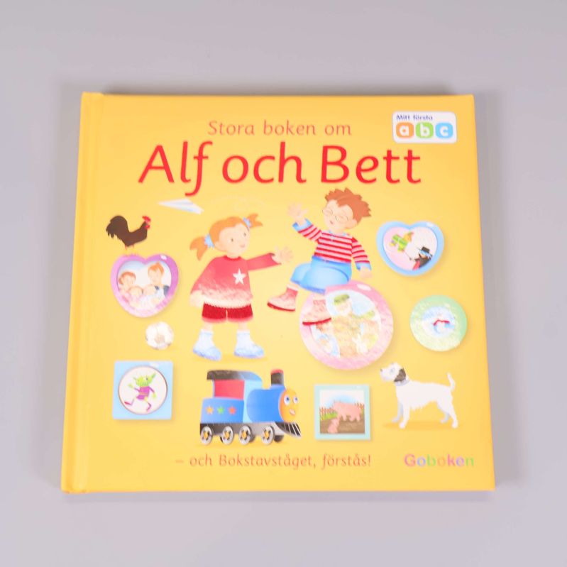Framsida av Stora boken om Alf och Bett, gul pärm med figurer
