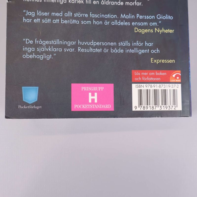 Närbild på baksidan där ISBN och etiketter syns