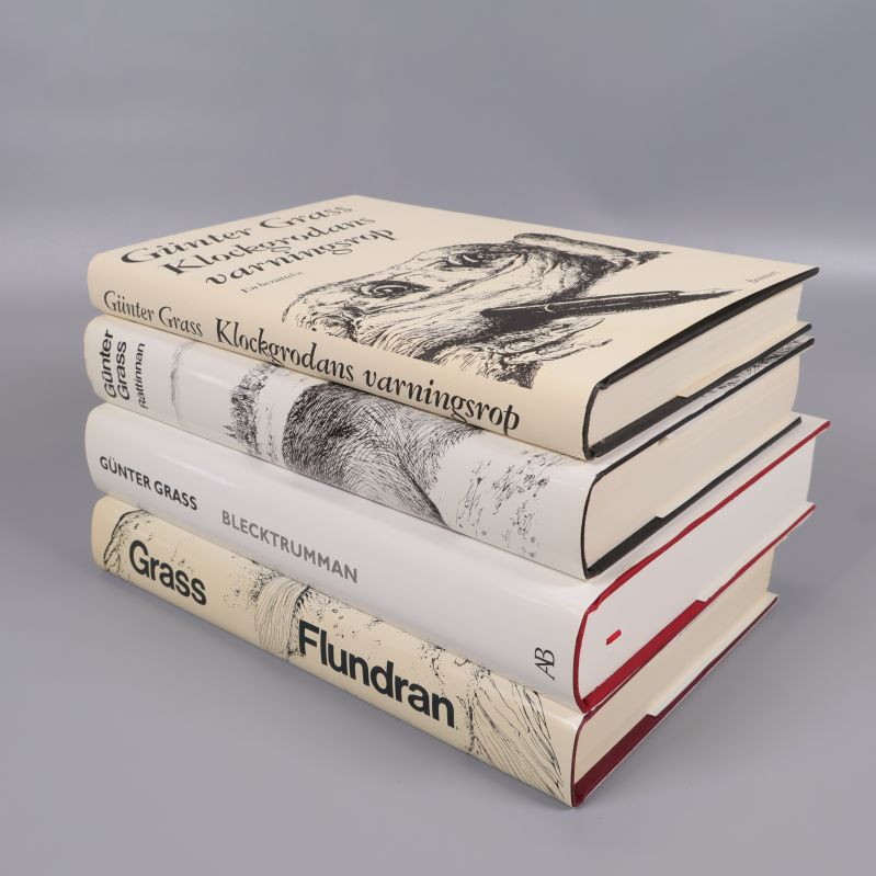 Fyra staplade Günter Grass böcker med illustrationer på ryggarna