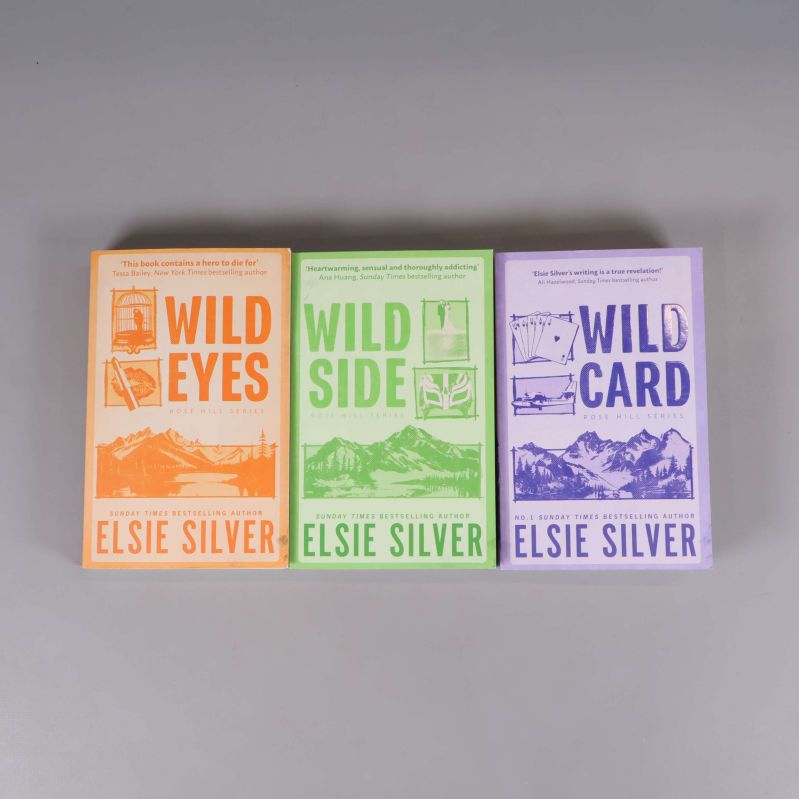 Tre böcker ur Rose Hill-serien av Elsie Silver med färgstarka omslag i orange, grönt och lila