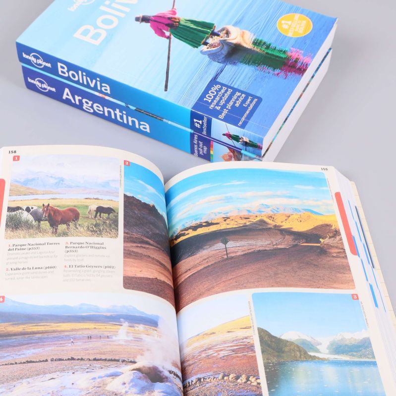 Uppslag i Lonely Planet-bok med färgglada foton och landskap