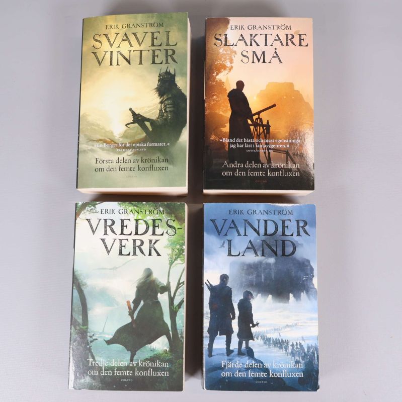 Fyra böcker av Erik Granström, framsidor mot kameran, olika färger och fantasymotiv