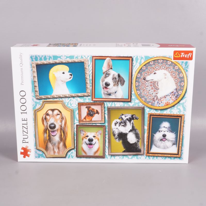 Framsida av pusselask med porträtt av hundar i ramar
