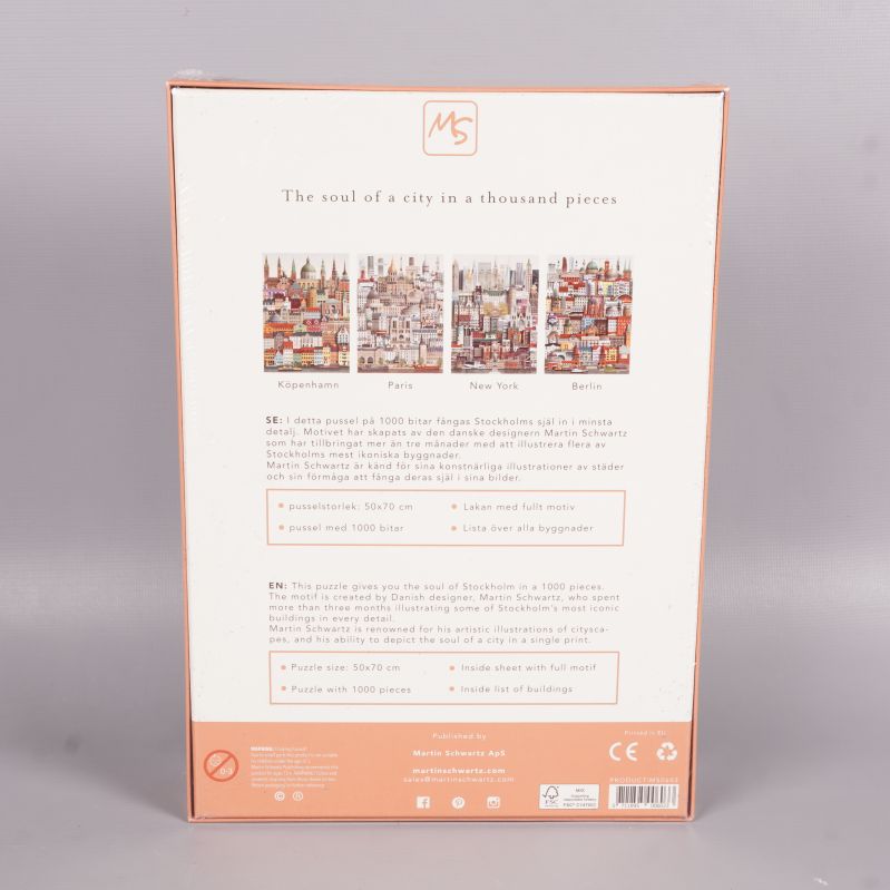 Baksidan av pusselboxen med beskrivning och andra städer