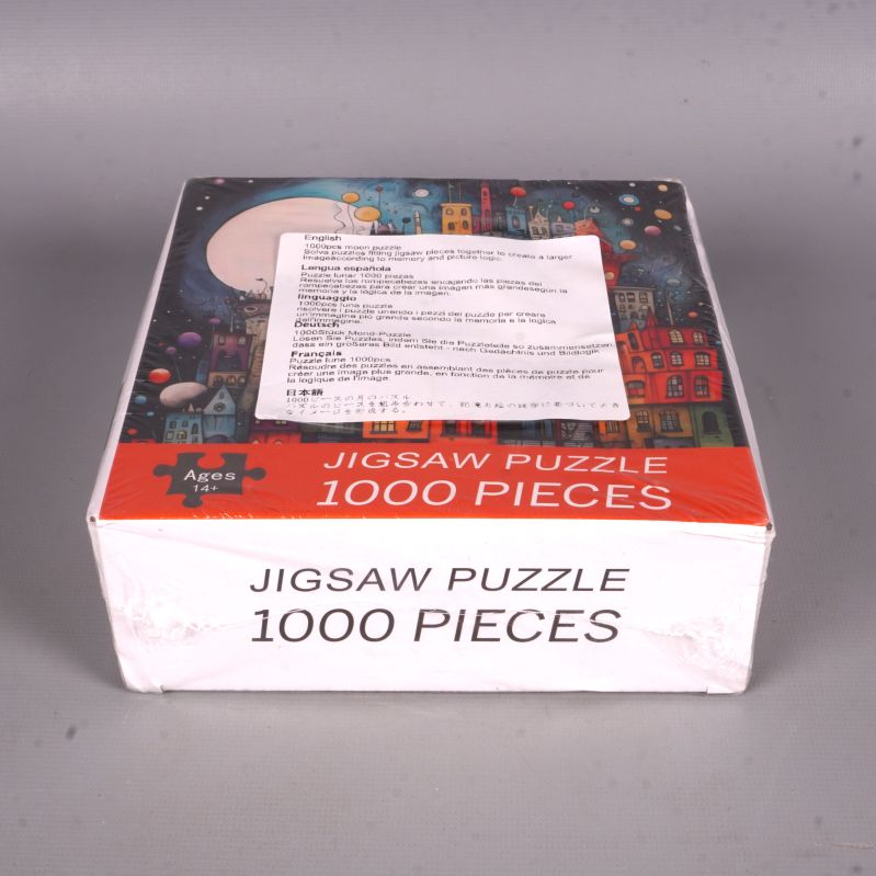 Pussellåda liggande med 1000 bitar tydligt markerat