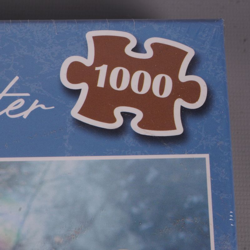 Pusselbit-symbol med texten 1000 i övre hörnet av lådan