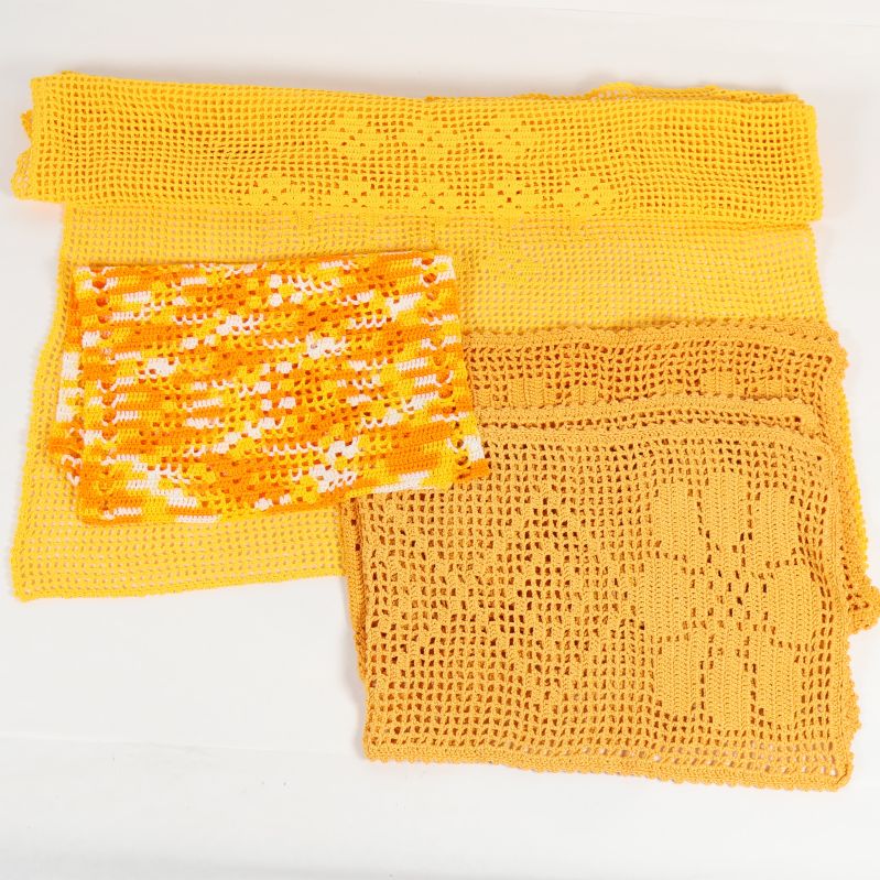 Tre stora och en liten virkad duk i gula toner