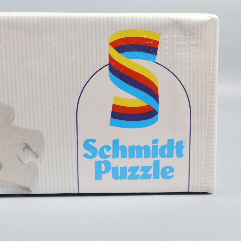 Schmidt Puzzle logotyp i blått med färgglad S