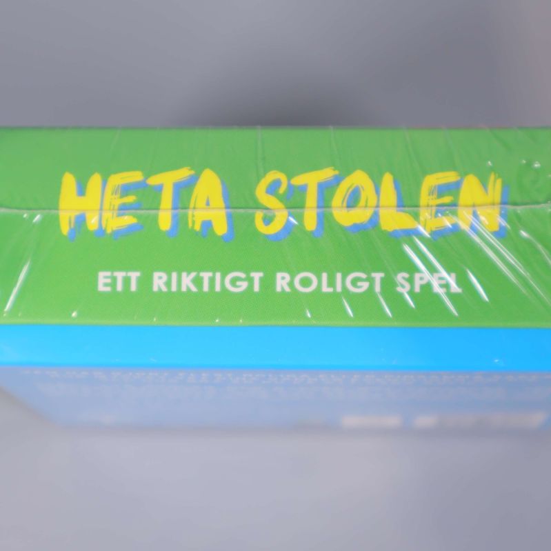 Överdel av Heta Stolen kartongen med speltext