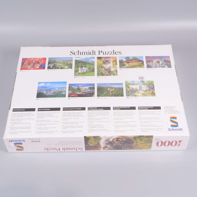 Baksidan på pussellådan visar fler motiv från Schmidt