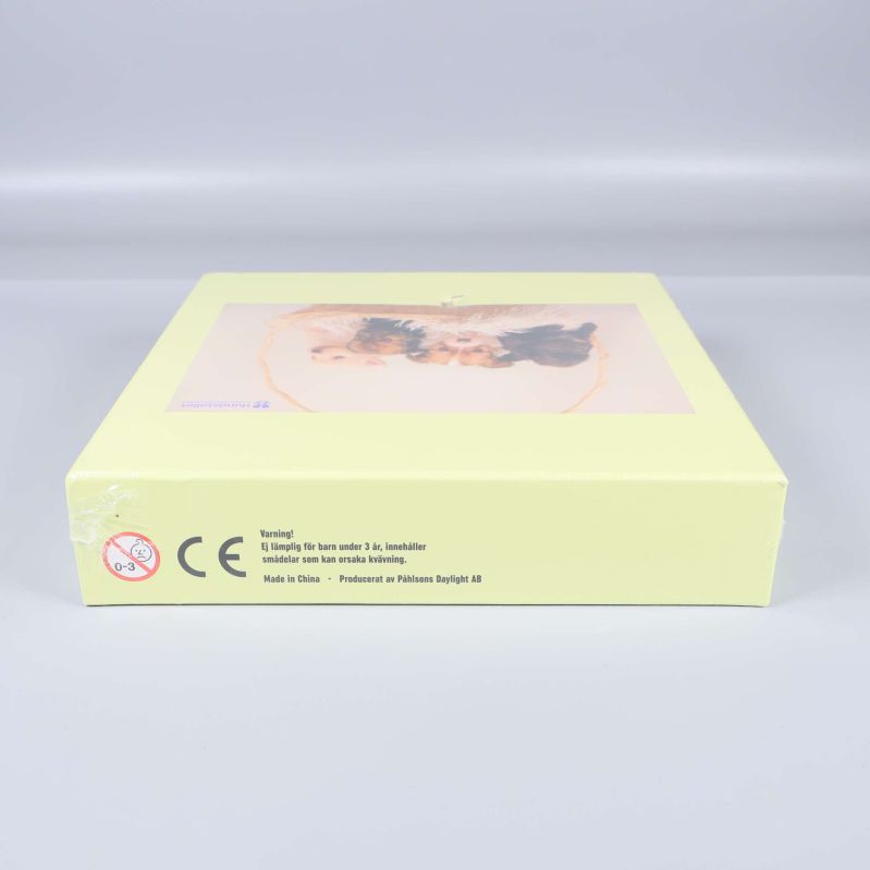 Undersida av pusselask med CE-märkning och varningssymbol