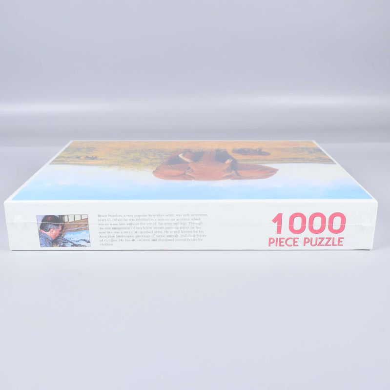 Sidan av pussellådan visar texten 1000 piece puzzle i rött