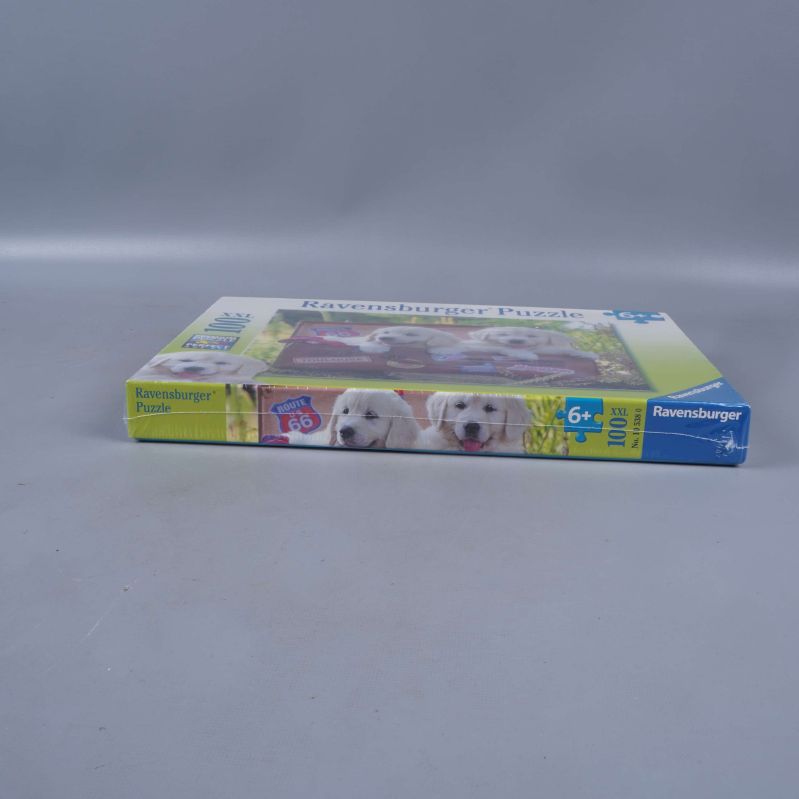 Ravensburger pusselask med hundvalpsmotiv sedd från sidan