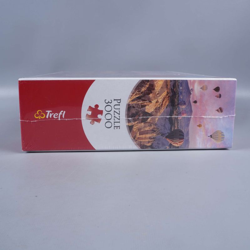 Sida på pusselask med luftballonger och text puzzle 3000