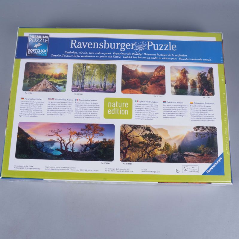 Baksidan av pusselkartong visar olika naturmotiv och information på flera språk