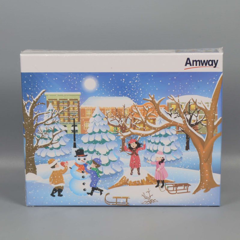 Framsida av pussellåda med vinterscen och Amway-logotyp