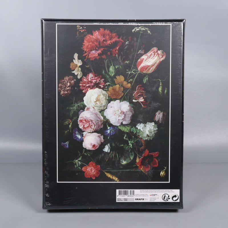 Baksidan av pussellådan med samma blomstermotiv och information