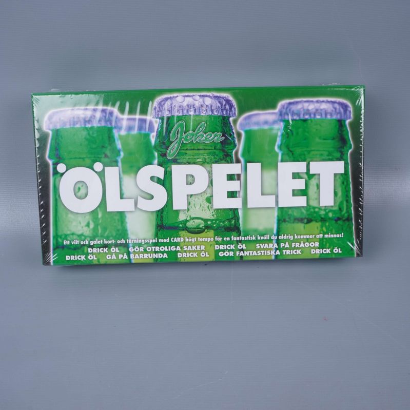 Ölspelets framsida med flaskmotiv och stor text