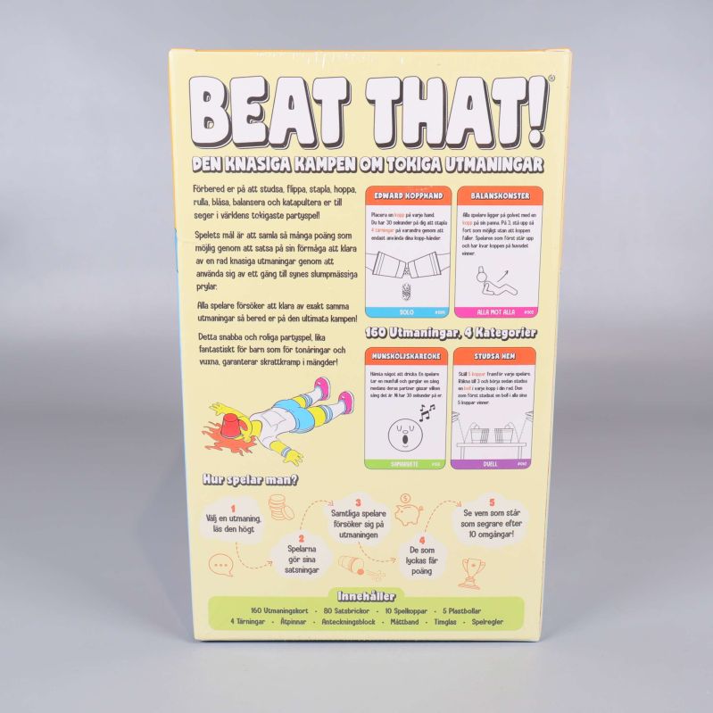 Baksidan av Beat That visar spelets beskrivning och exempel på utmaningar