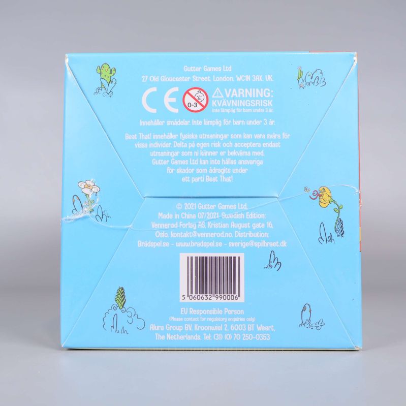 Undersidan av Beat That visar varningsmärkning och tillverkardetaljer
