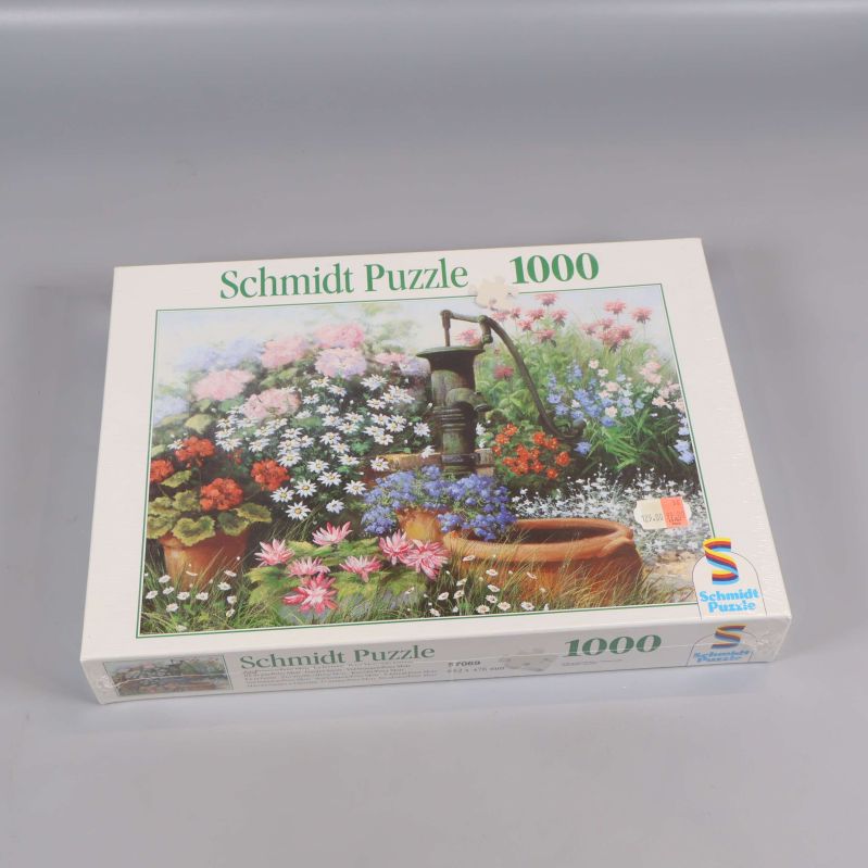 Schmidt Puzzle 1000 bitar med blomsterdesign på locket