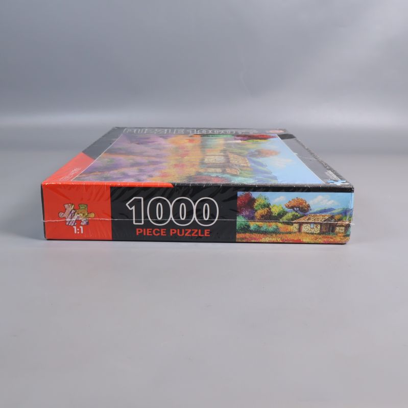 Kort gavelsida av pussellåda med 1000 piece puzzle-text