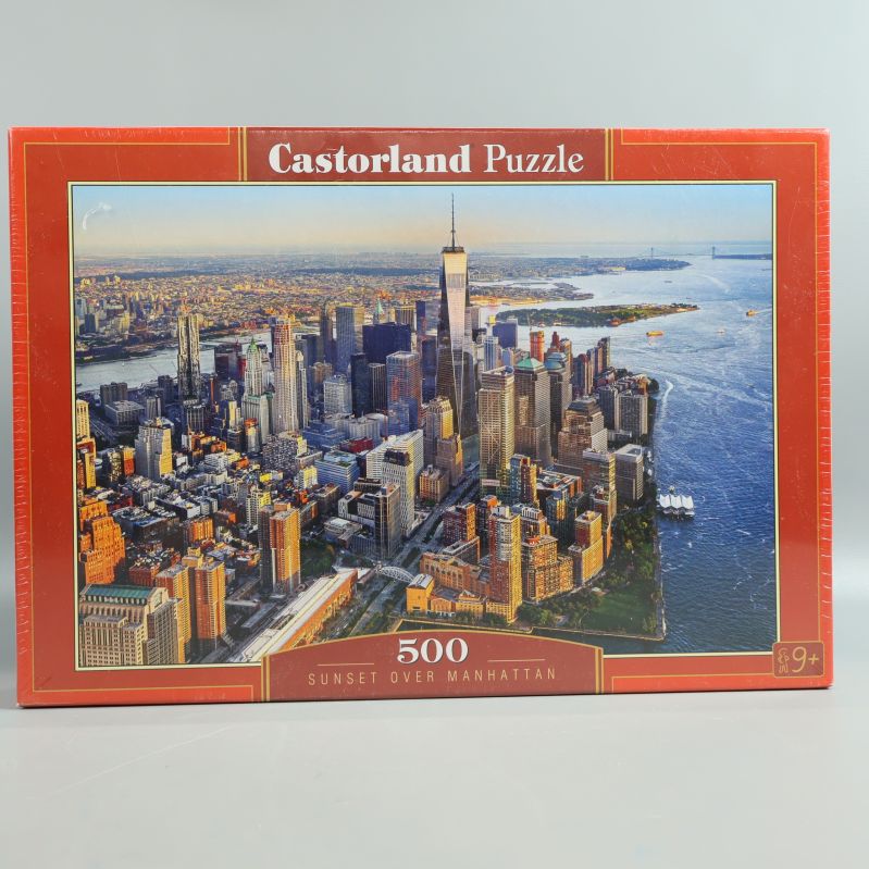 Framsidan av Castorland Puzzle med Manhattan-motiv i solnedgång