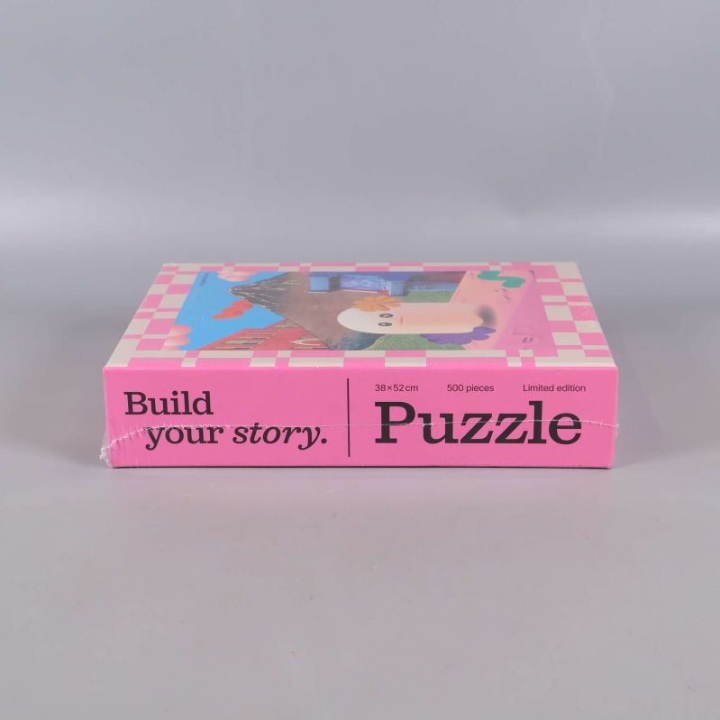 Nedre kant av asken med texten Build your story Puzzle