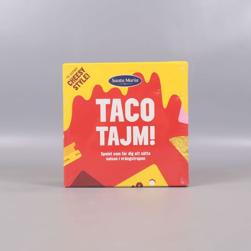 Framsidan av Taco Tajm sällskapsspel med färgglad design