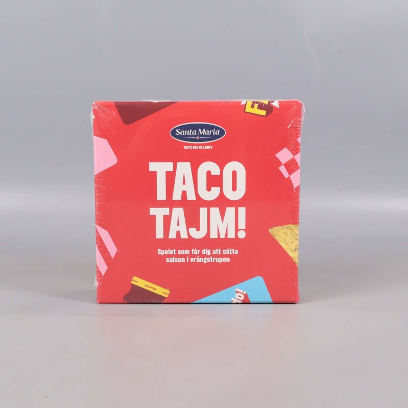 Framsidan av spelet Taco Tajm med röd box och stora vita bokstäver