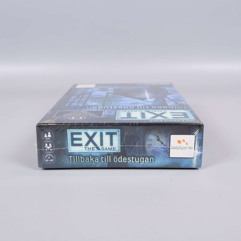 Nedre kant av spelboxen för Exit the Game Tillbaka till ödestugan