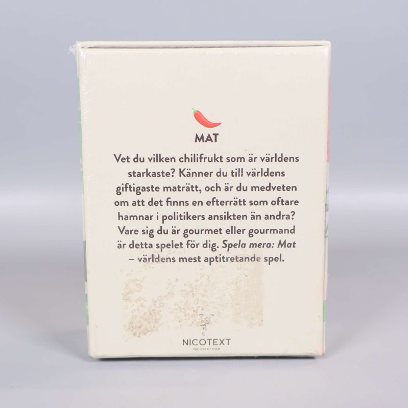 Framsidan av Mat-spelet med gröna och orangea illustrationer