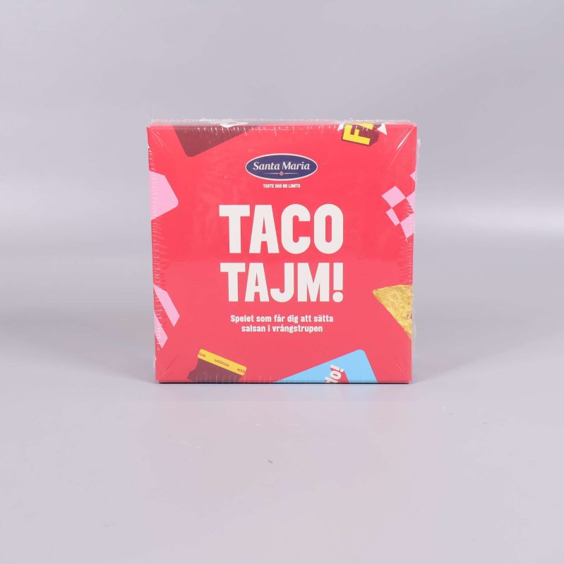 Framsidan av Taco Tajm-spel i röd förpackning