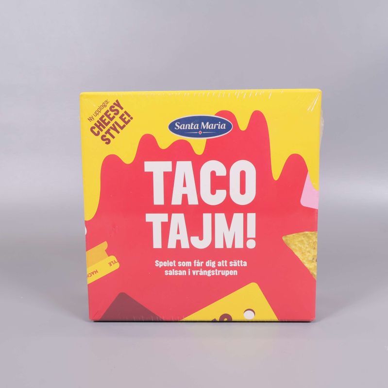 Framsidan av Taco Tajm sällskapsspel i gul och röd design