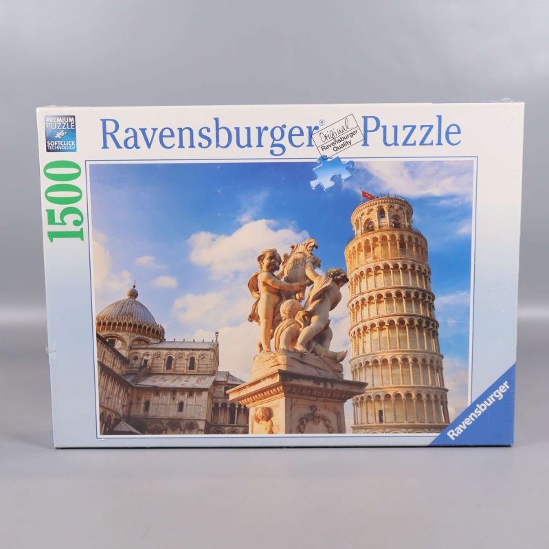 Framsida av Ravensburger pussellåda med motiv av tornet i Pisa