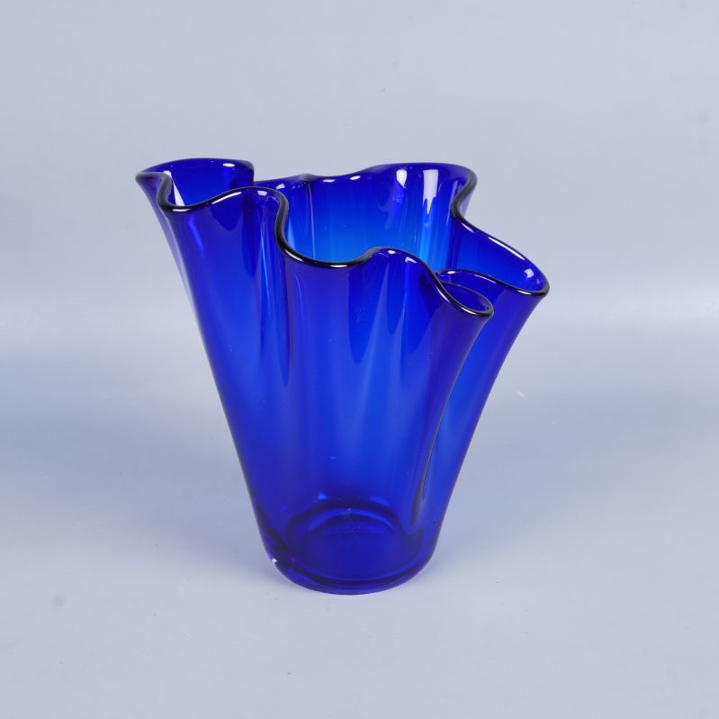 Blå glasvas i konstnärlig vågformad design