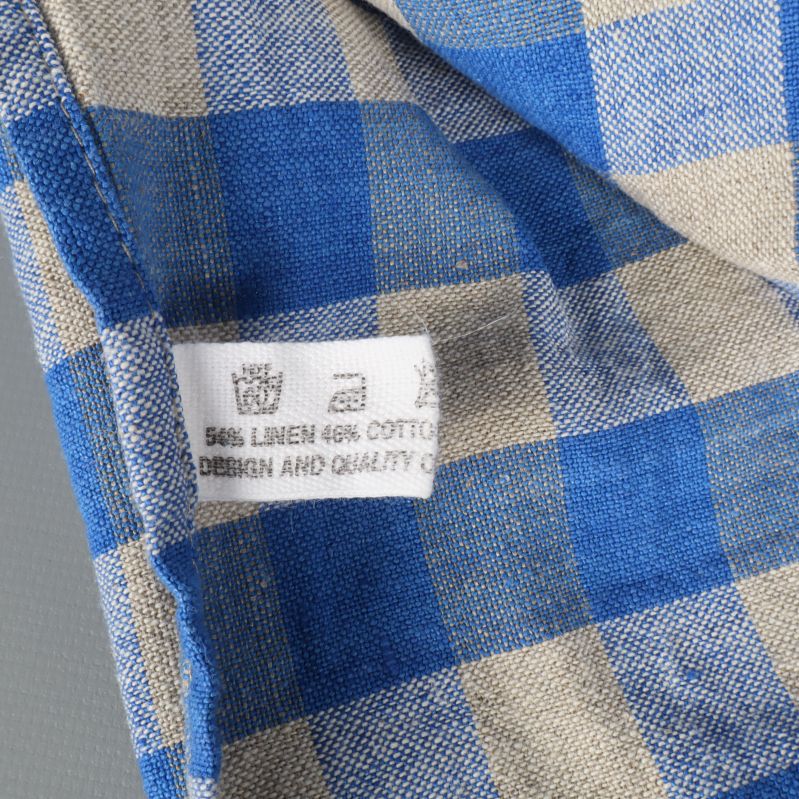 Tvättrådsetikett med information om materialblandning linne och bomull