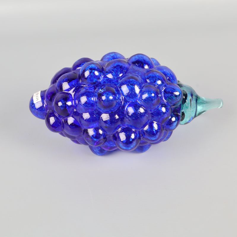 Blå glasdruva liggande med grön stjälk