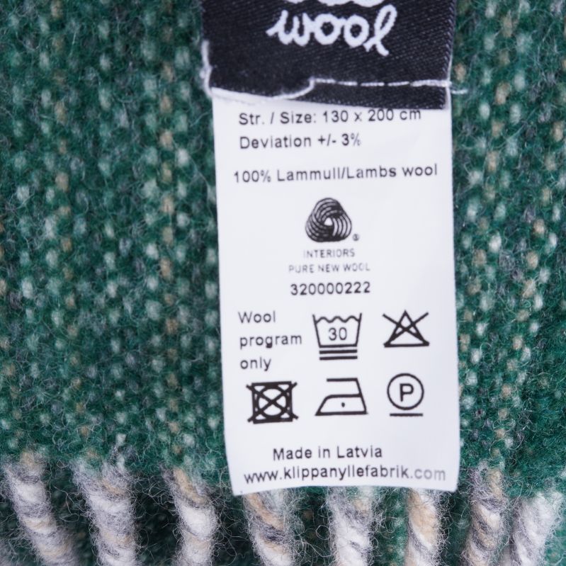 Tvättrådsetikett med material och skötselråd